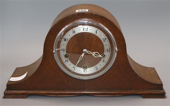 A 1930s oak mantel clock